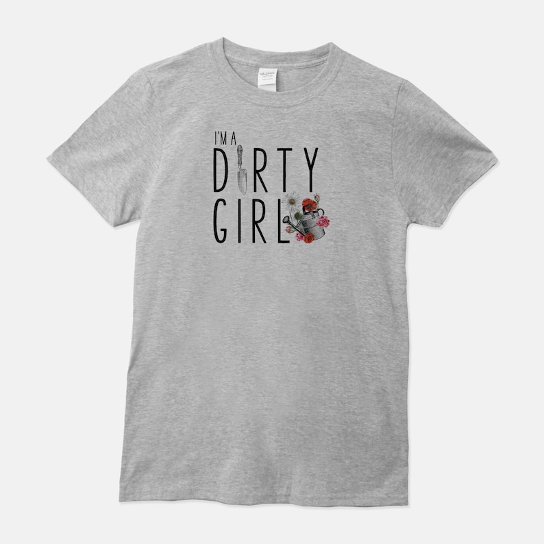 May include: A gray t-shirt with the text "I'm a Dirty Girl" in black lettering. The text is accompanied by a gardening-themed illustration of a trowel, watering can, and flowers.
