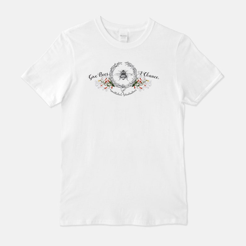 May include: White t-shirt with a graphic of a bee in a wreath of flowers and the text "Give Bees a Chance.  Pollinators of Happiness."