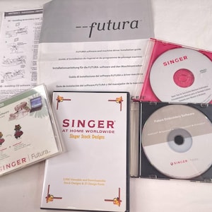 May include: A collection of Singer Futura embroidery software components including a printed installation guide, a Singer At Home Worldwide stock designs DVD case, and two additional software discs in clear plastic cases with branded labels.