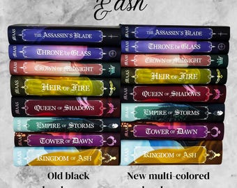 May include: Two stacks of hardcover books with titles like "The Assassin's Blade" and "Throne of Glass." One stack features black covers, while the other showcases multi-colored spines. The text "Old black hardcovers" and "New multi-colored hardcovers" is visible.