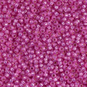 May include: A large quantity of small, round, iridescent pink seed beads. The beads have a metallic sheen and are perfect for jewelry making.