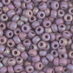 May include: A close-up of a pile of small, round, iridescent purple beads. The beads have a matte finish and are perfect for jewelry making.