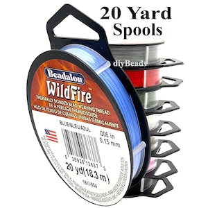 May include: A stack of Beadalon WildFire thermally bonded bead weaving thread spools, each containing 20 yards of 0.006 inch thick thread. The front spool is blue, with other spools in various colors visible behind it, all on black plastic holders.