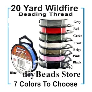May include: A collection of 20 Yard Wildfire Beading Thread spools in seven distinct colors: blue, grey, red, green, frost, beige, pink, and black. Each spool is labeled with the Beadalon Wildfire brand name and includes 20 yards of thread.