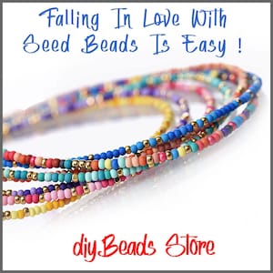 May include: Multiple strands of colorful seed beads interspersed with small metallic gold beads. The text at the top reads Falling In Love With Seed Beads Is Easy! and the text at the bottom reads diyBeads Store.