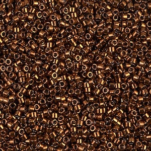 May include: A close-up view of a large quantity of small, round, copper-colored beads. The beads are arranged in a random pattern, creating a textured surface.