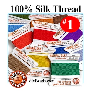 May include: A collection of Griffin brand natural silk thread spools in various colors including red, yellow, green, blue, purple, and brown. Each white cardboard card features the text Natural Silk 100% Naturseide and For stringing pearls and beads.