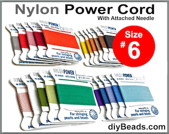 May include: Assortment of nylon power cords in various colors, each with a needle attached. The cords are labeled "Nylon Power" and are for stringing pearls and beads. Size #6.