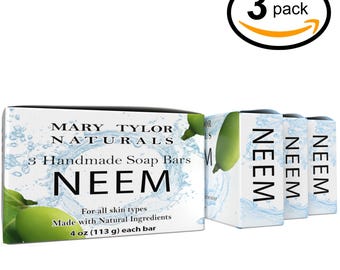 May include: A three-pack of Mary Tylor Naturals neem soap bars. Each rectangular box features a green neem leaf graphic, blue water splash design, and text stating 3 Handmade Soap Bars, NEEM, and 4 oz (113 g) each bar.