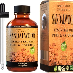 May include: A brown glass bottle with a dropper, labeled "Sandalwood Essential Oil Pure & Natural" with a 100% plant-based label. The bottle is sitting on a white surface. The bottle is 1 fluid ounce (30 ml).