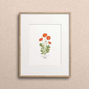 May include: A framed print with a white background featuring a botanical illustration of a poppy flower with the text "AUGUST Poppy" below the image.