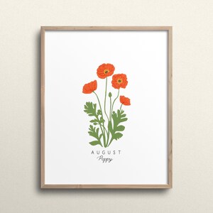 May include: A framed print with a white background featuring a drawing of orange poppy flowers with green stems and leaves. The text "AUGUST Poppy" is printed below the flowers.
