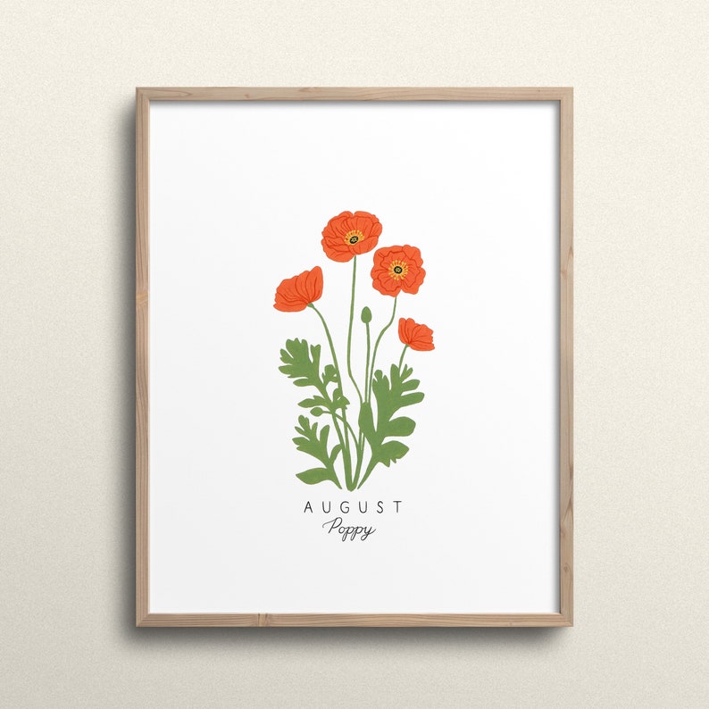 May include: A framed print with a white background featuring a drawing of orange poppy flowers with green stems and leaves. The text "AUGUST Poppy" is printed below the flowers.