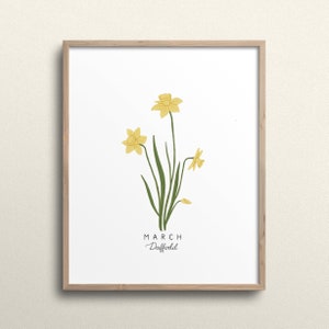 May include: A framed print with a white background featuring a yellow daffodil flower with green leaves. The text "MARCH Daffodil" is printed below the flower.