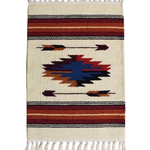 May include: A rectangular woven rug featuring an off-white base with horizontal stripes in shades of red, orange, and black. The center displays a geometric diamond pattern in blue, red, and brown, flanked by two horizontal arrows with fringe.