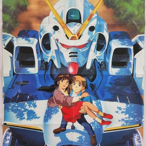 May include: A poster for "Mobile Suit Victory Gundam" featuring a large blue and white robot with yellow accents. Two children are in front of the robot. The poster has the text "Newtype" in the bottom left corner.