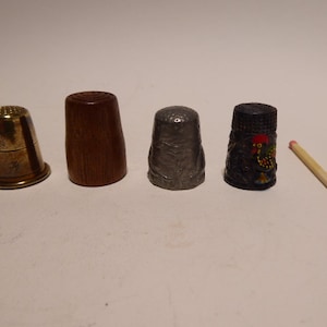 four thimbles of Wood, Pewter, Brass, mild Steel