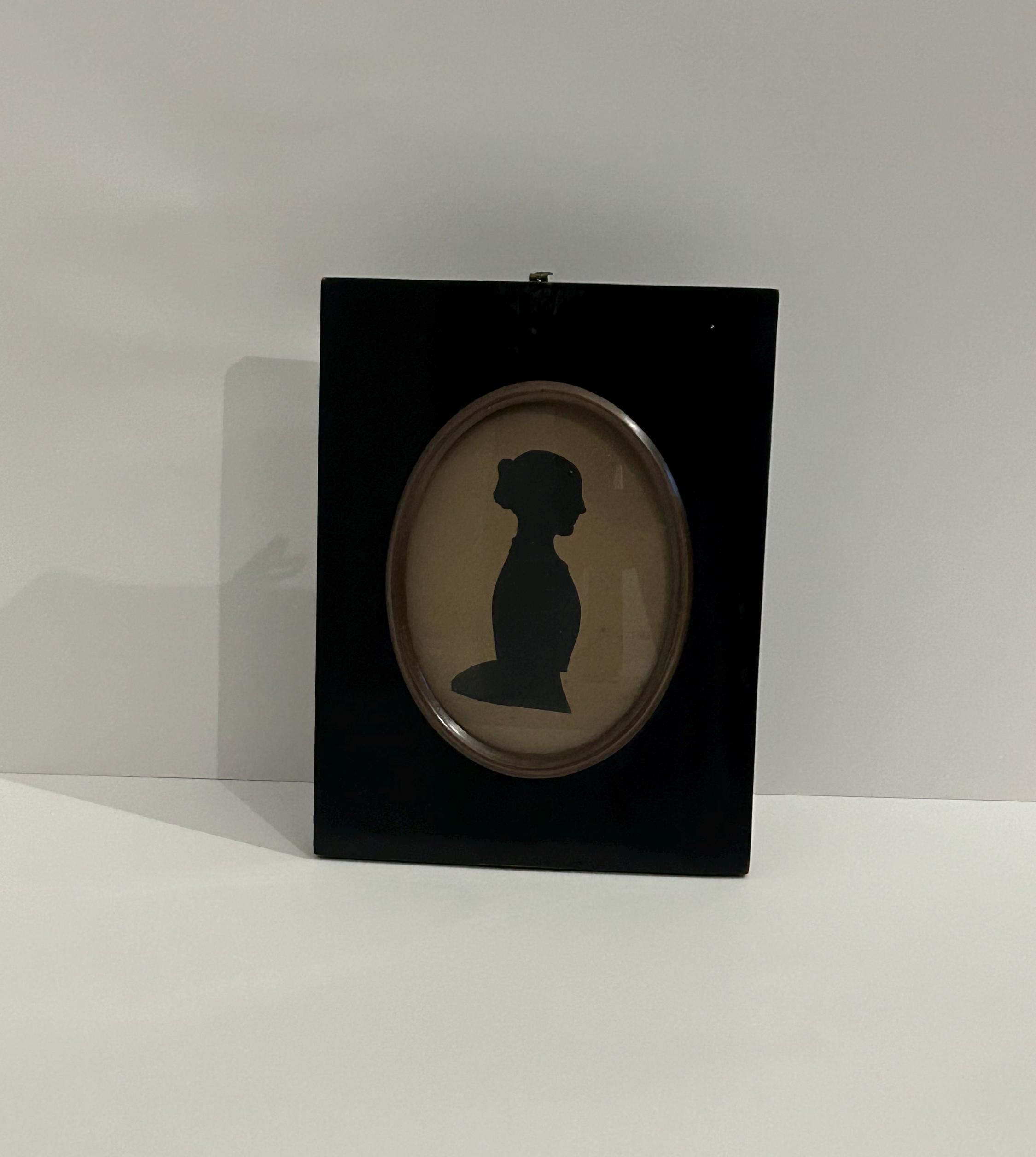 1800s Victorian oval silhouette depicting a young lady, mounted in a strut frame. Also known as Shades