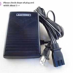 May include: Black electronic foot pedal with a cord and two plugs. The foot pedal has the word "ELECTRONIC" printed on it. The plug is about 1 inch wide.