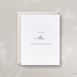 May include: A white card with the text "To my Mom on my wedding day" in black calligraphy.
