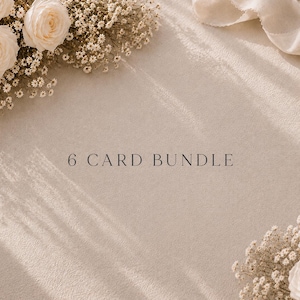 May include: A 6 CARD BUNDLE text display on a textured beige surface, framed by cream-colored roses and small white baby's breath flowers. A piece of light-colored fabric ribbon is visible in the upper right corner, with soft shadows cast across.