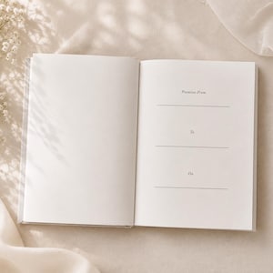 May include: An open book with blank white pages. The right page features printed text in a serif font with the headings Promises From, To, and On, each followed by a horizontal line for writing. The paper is smooth and matte in texture.