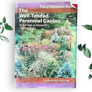 May include: Book cover with a purple background and the title "The Well-Tended Perennial Garden: Planting & Pruning Techniques" in white text. The cover features a photo of a lush, colorful perennial garden with a variety of plants and flowers.