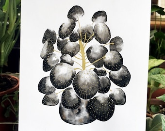 May include: Watercolor painting of a plant with round, dark gray leaves and a golden stem. The leaves have small gold speckles. The artwork is on white paper and held in front of a background of green plants.