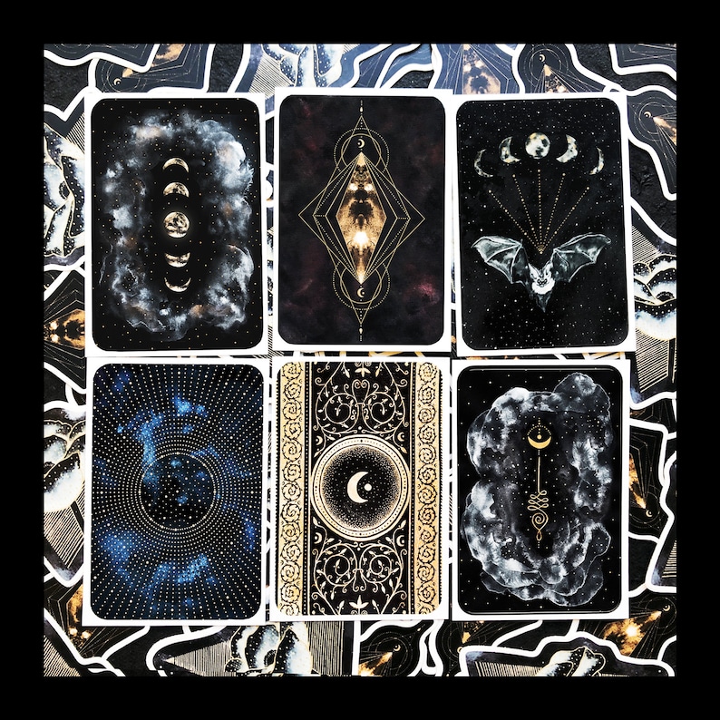 May include: Six black and gold decorative stickers with celestial and moon imagery. The stickers feature a crescent moon, stars, a bat, and a stylized moon with a face.