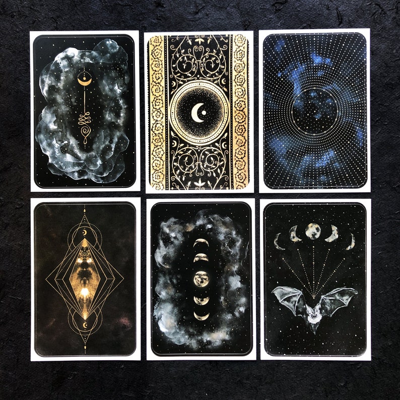 May include: Set of six black and gold tarot cards with celestial and geometric designs. The cards feature moons, stars, and other celestial imagery.