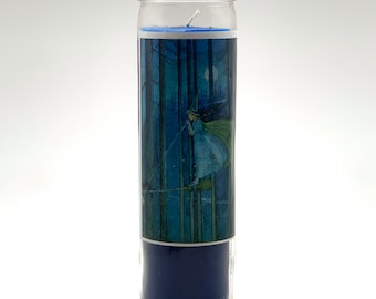 May include: A blue glass candle with a picture of a witch flying on a broomstick in a forest at night. The candle is in a clear glass jar.