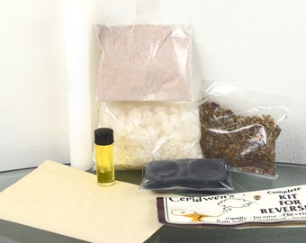 May include: A complete kit for reversing, containing a candle, incense, oil, herbs, bath salts, and instructions. The kit is packaged in clear plastic bags and labeled "Ceridwen's Complete Kit for Reversing".
