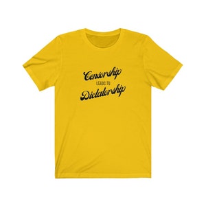 May include: Yellow t-shirt with black text that reads "Censorship Leads to Dictatorship".