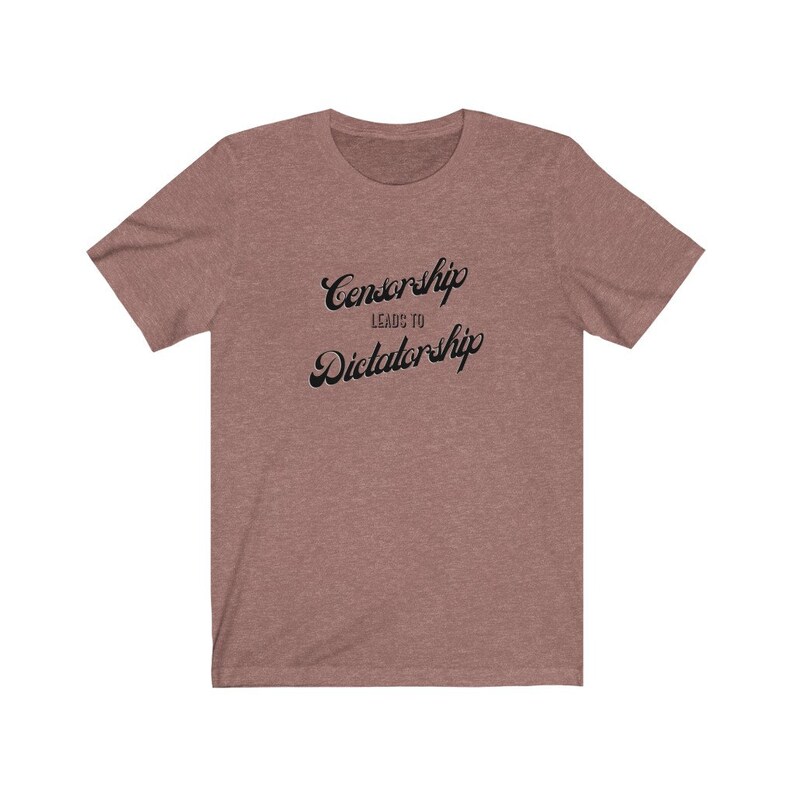 May include: A heather brown t-shirt with the text "Censorship Leads to Dictatorship" printed in black.