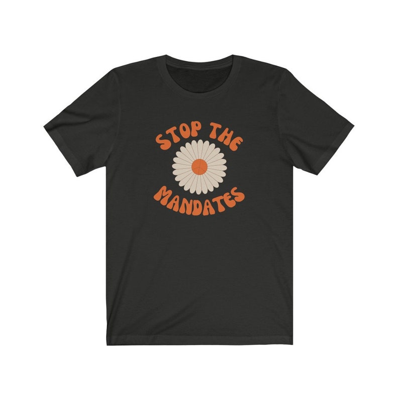 May include: Black t-shirt with a daisy graphic and the text "STOP THE MANDATES" in orange.