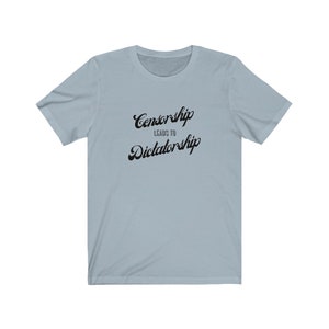 May include: Light blue t-shirt with black text that reads "Censorship Leads to Dictatorship".