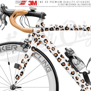 May include: A white road bike with a leopard print design. The bike has a brown handlebar and black wheels. The text "MR.STICKERCLING" is printed on the side of the bike.