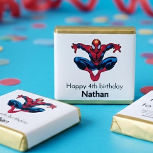 May include: Personalised chocolate Neapolitans with a Spider-Man graphic. The white wrappers feature the text "Happy 4th birthday Nathan". The chocolate bars are wrapped in gold foil and are ideal for a birthday party.
