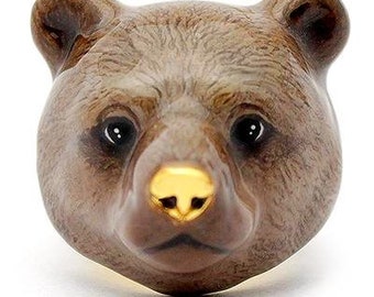 May include: A brown bear head ring with a gold nose. The bear has a realistic fur texture and a detailed face.