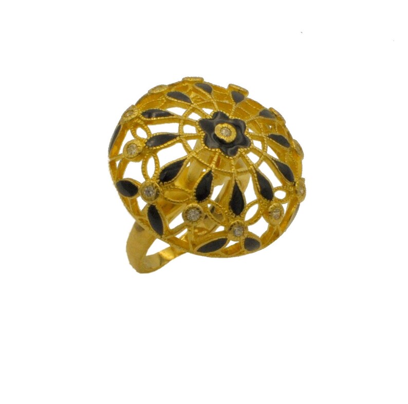 May include: A gold ring with a black enamel design. The ring features a large, round, dome-shaped top with a delicate floral pattern. The centre of the dome has a small black flower with a white centre.