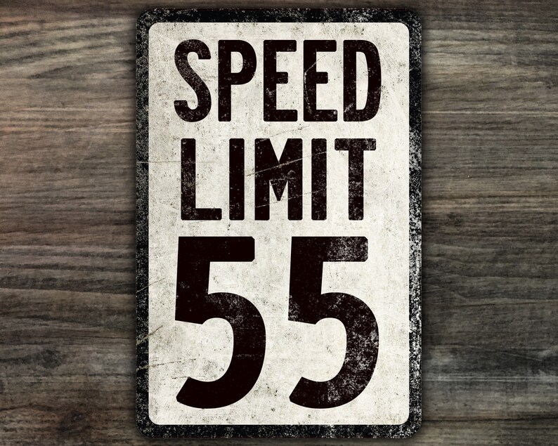 May include: A vintage-style speed limit sign with a white background and black lettering. The sign reads "SPEED LIMIT 55".