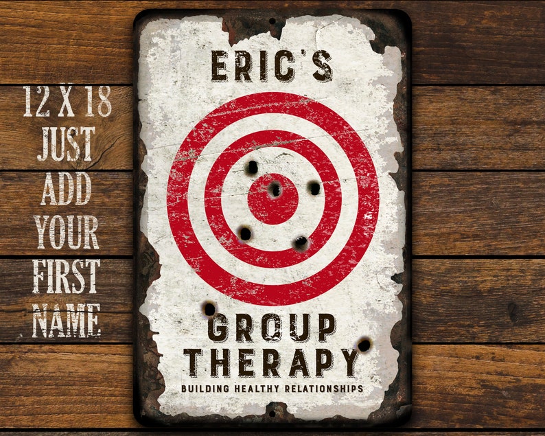 May include: A white metal sign with a red and white target in the center. The sign says "Eric's Group Therapy Building Healthy Relationships".