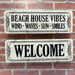 Vintage Style White Metal Wall Plaque with Weathered Appearance