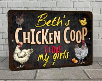 May include: A black metal sign with a rustic design featuring a chicken coop with the text "Beth's Chicken Coop I love my girls". The sign has a yellow background with red and white accents.