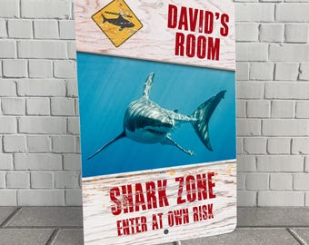 May include: A blue and white metal sign with a shark illustration and the text "David's Room" and "Shark Zone Enter at Own Risk".