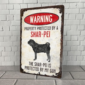 May include: A warning sign with a distressed metal look. The sign reads "WARNING PROPERTY PROTECTED BY A SHAR-PEI THE SHAR-PEI IS PROTECTED BY MY GUN". A black silhouette of a Shar-Pei dog is in the center of the sign.