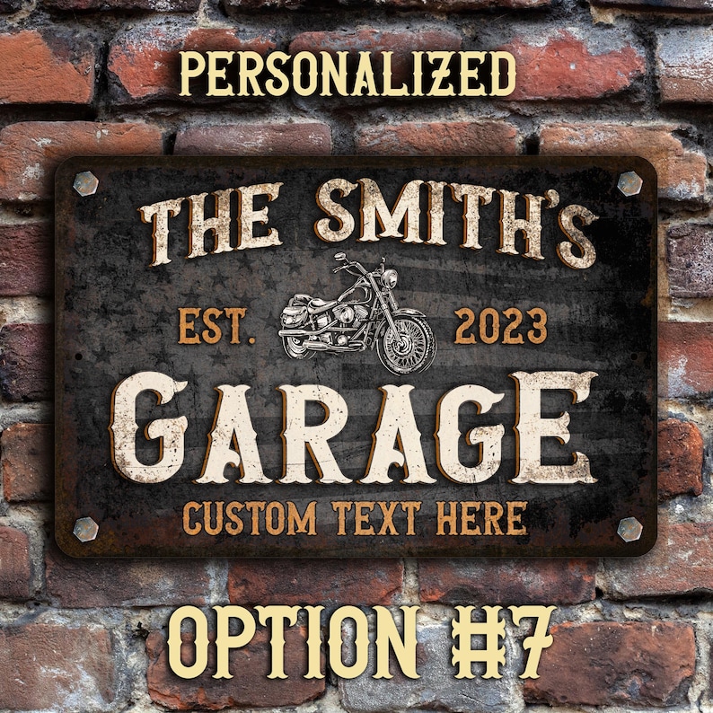 May include: Personalized metal sign with a distressed black background and white lettering. The sign reads "The Smith's Garage Est. 2023 Custom Text Here". A vintage motorcycle illustration is featured in the center of the sign.