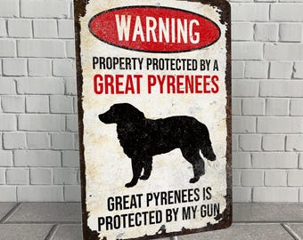 May include: A warning sign with a distressed metal look. It reads "Warning, Property Protected by a Great Pyrenees, Great Pyrenees is Protected by My Gun". A black silhouette of a Great Pyrenees dog is in the center of the sign.