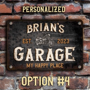 May include: Personalized garage sign with a distressed black background, white lettering, and a vintage motorcycle graphic. The sign reads "Brian's Garage Est. 2023 My Happy Place".