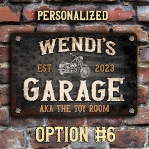 May include: A black and brown metal sign with the text "Wendi's Garage Est. 2023 AKA The Toy Room" and a motorcycle graphic. The sign has a distressed look and is personalized with a name and year.